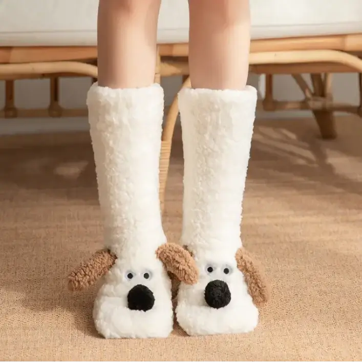 White fluffy dog-shaped socks with brown ears and black nose.