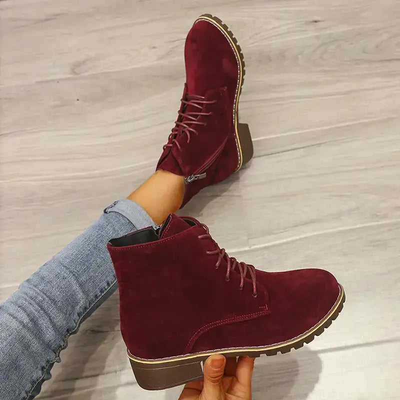 Maroon suede ankle boots with matching laces and a chunky brown heel.