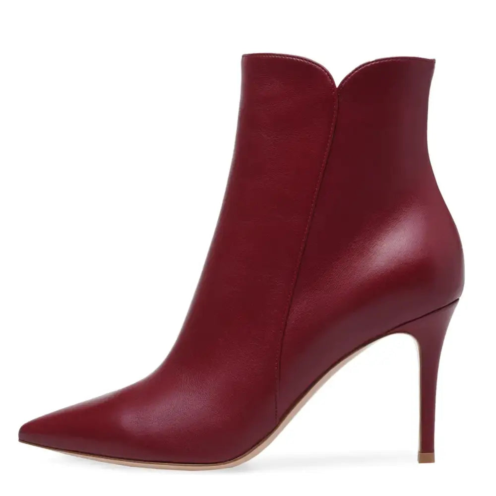A sleek, burgundy leather ankle boot with a pointed toe and slender high heel.