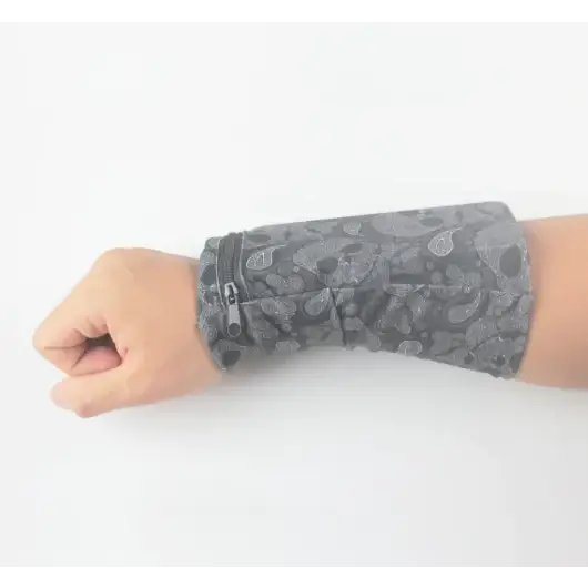 Gray patterned fabric wristband with zipper closure.