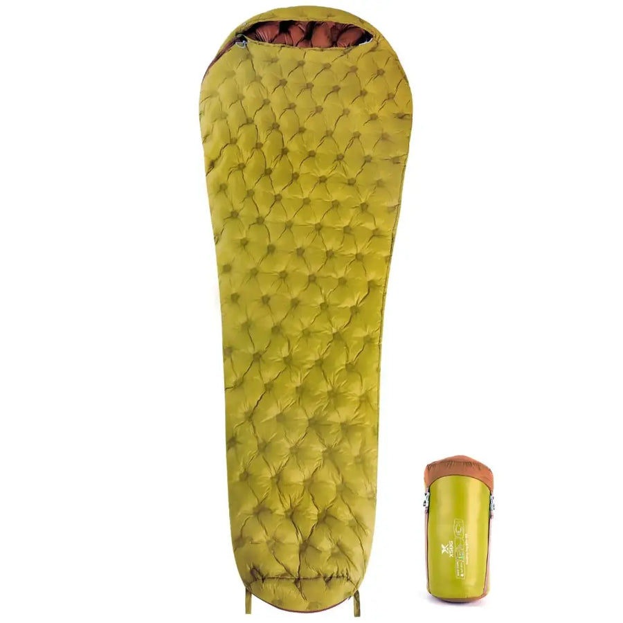 A lime green quilted sleeping bag with a brown zipper and interior lining, shown alongside its compact storage sack.